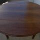 Table ronde ancienne à volets en bois noyer à roulettes