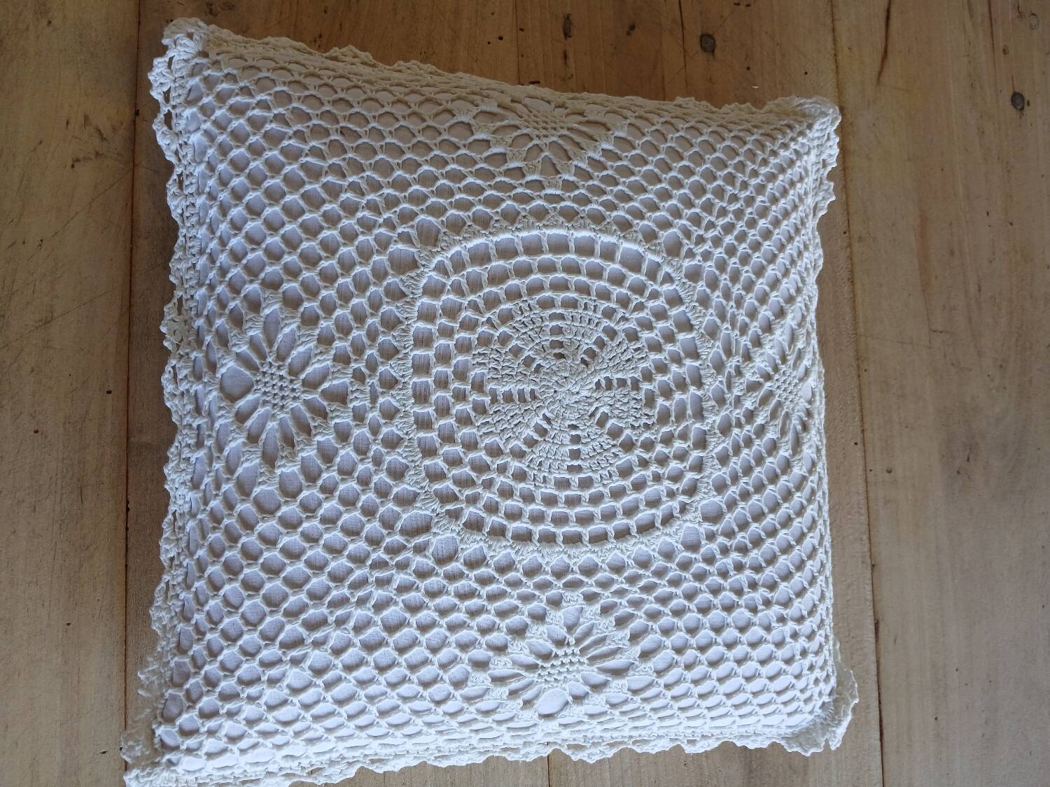 Cushion with white crochet cover