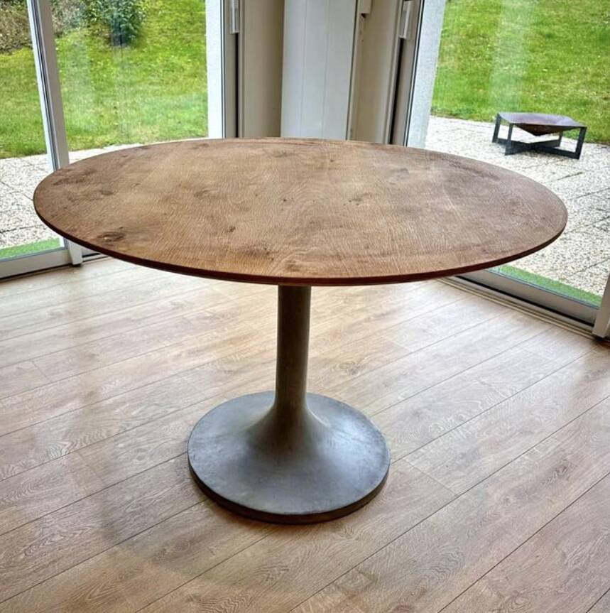 Round wooden table with concrete tulip base