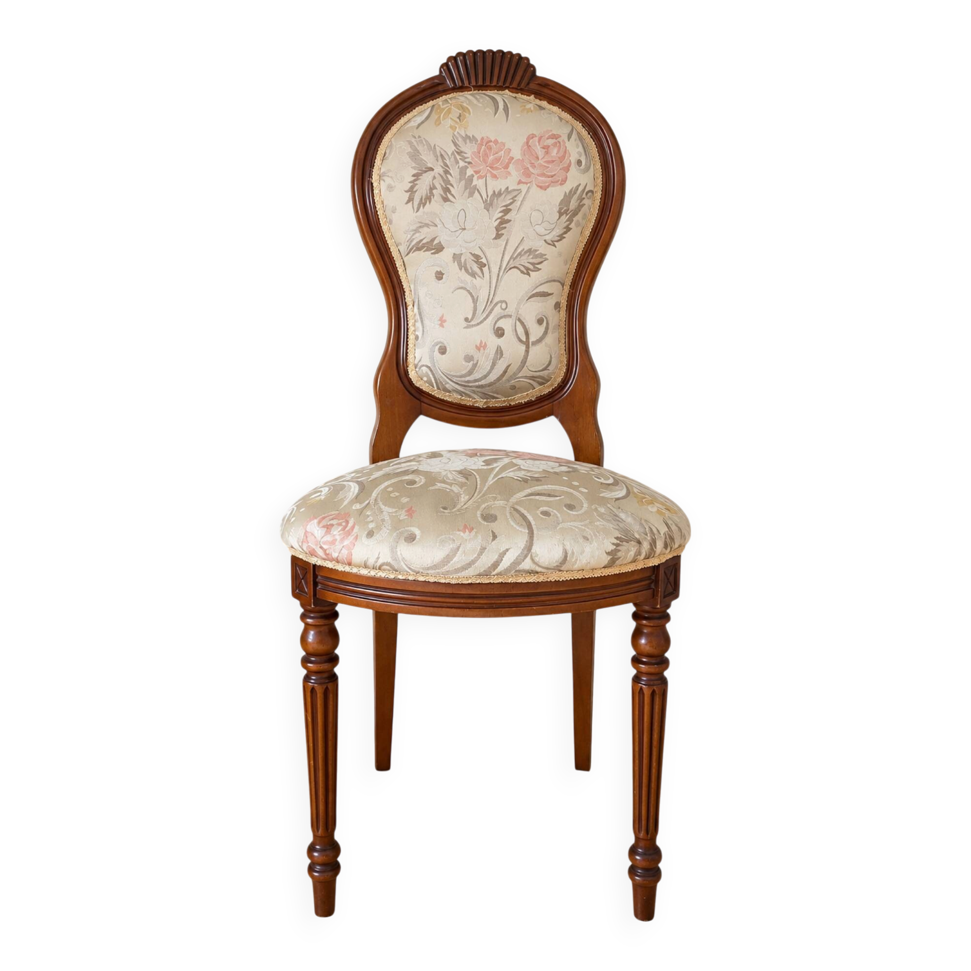 Antique Louis XVI style chair in wood and floral fabric.