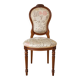 Antique Louis XVI style chair in wood and floral fabric.