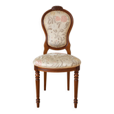 Antique Louis XVI style chair in wood and floral fabric.