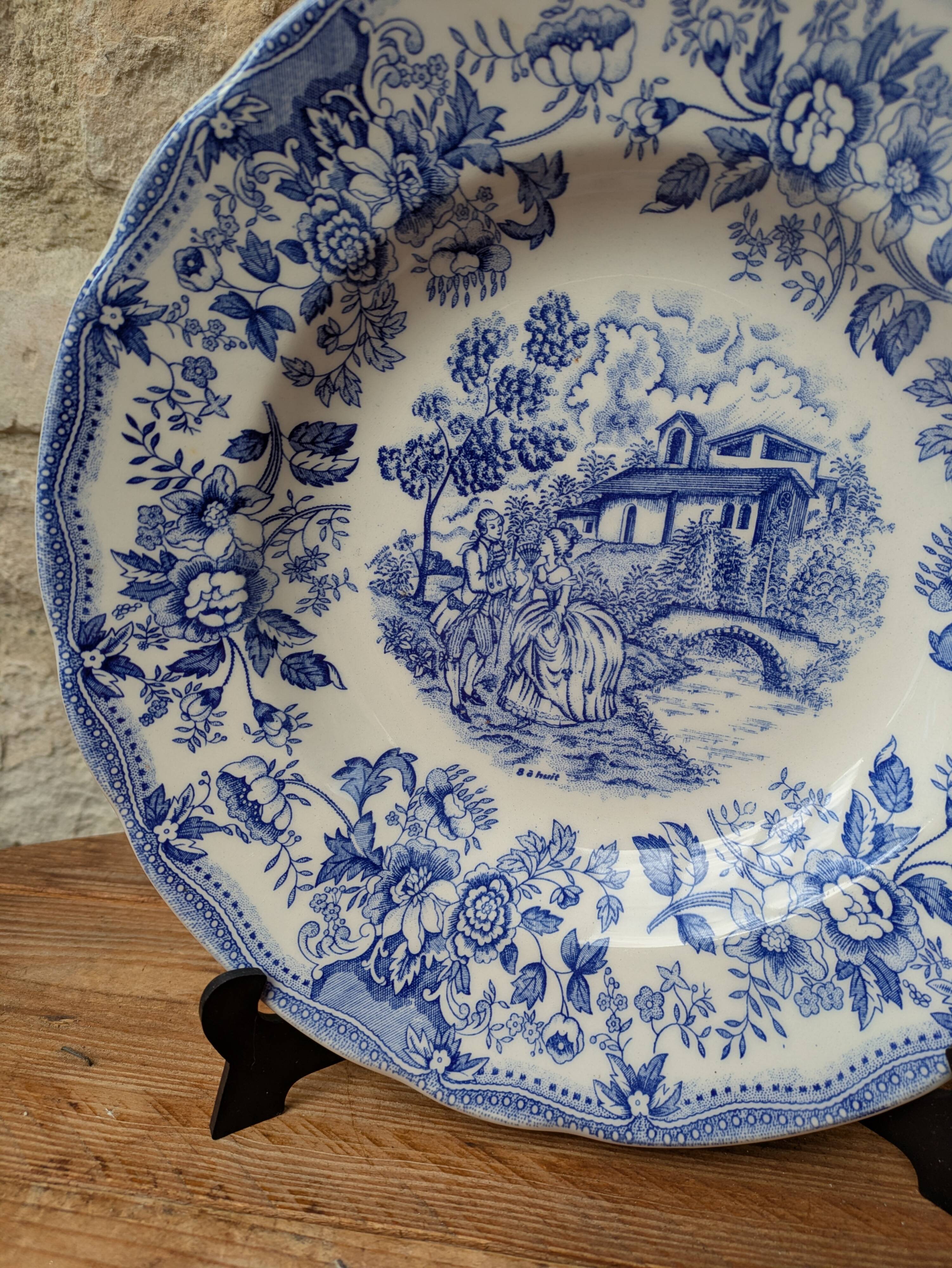 Old deep plate with blue floral pattern and gallant scene