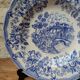 Old deep plate with blue floral pattern and gallant scene
