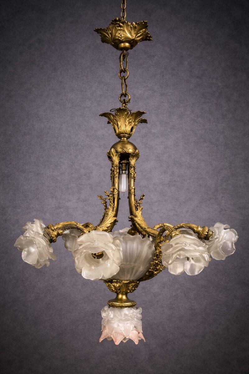 Rare and important gilded bronze chandelier with shells and roses.