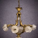Rare and important gilded bronze chandelier with shells and roses.