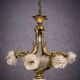 Rare and important gilded bronze chandelier with shells and roses.