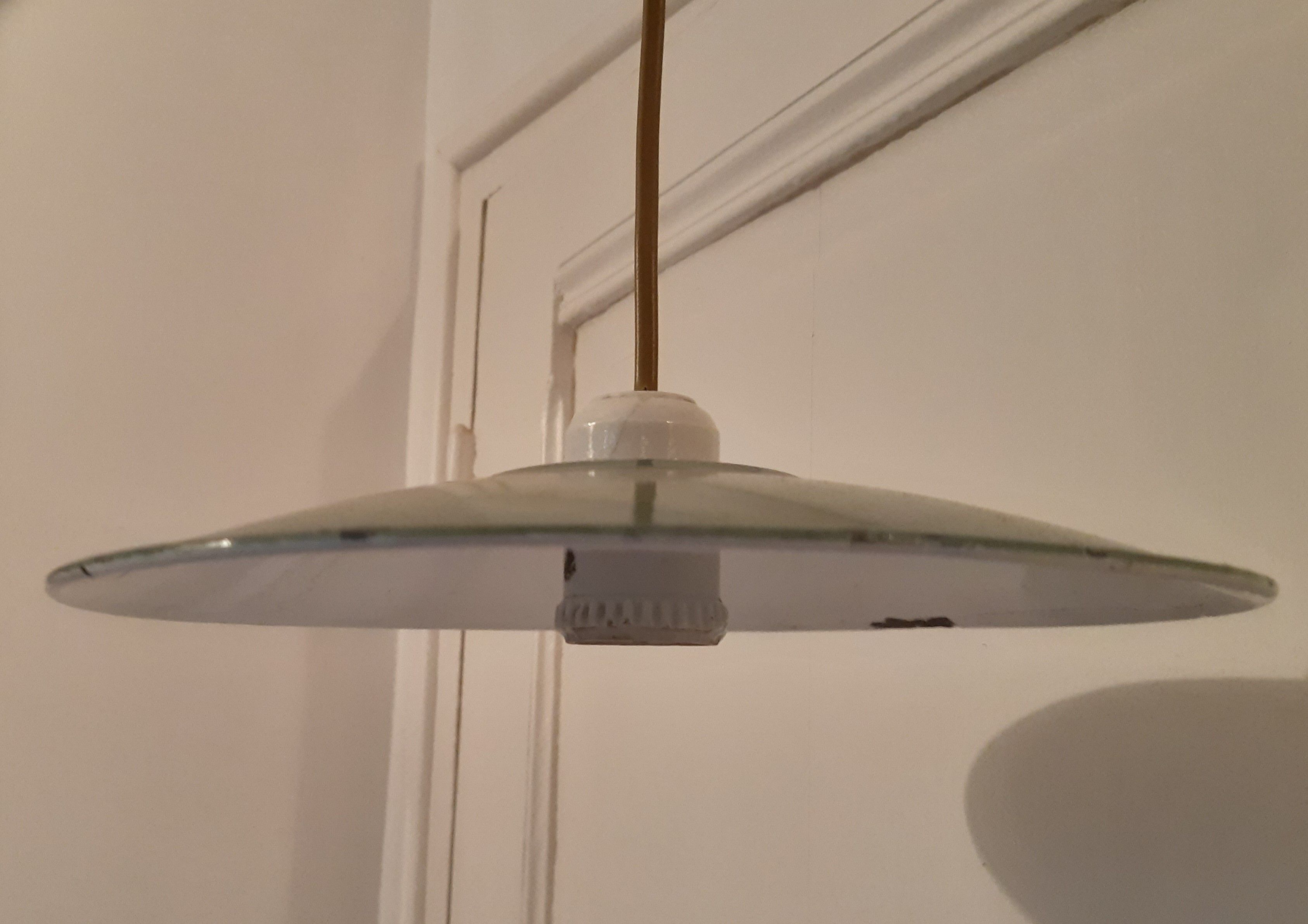 Old suspension in green enamelled sheet metal and porcelain socket to hang