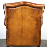 Sheepskin leather wingback armchair, with nails and black piping