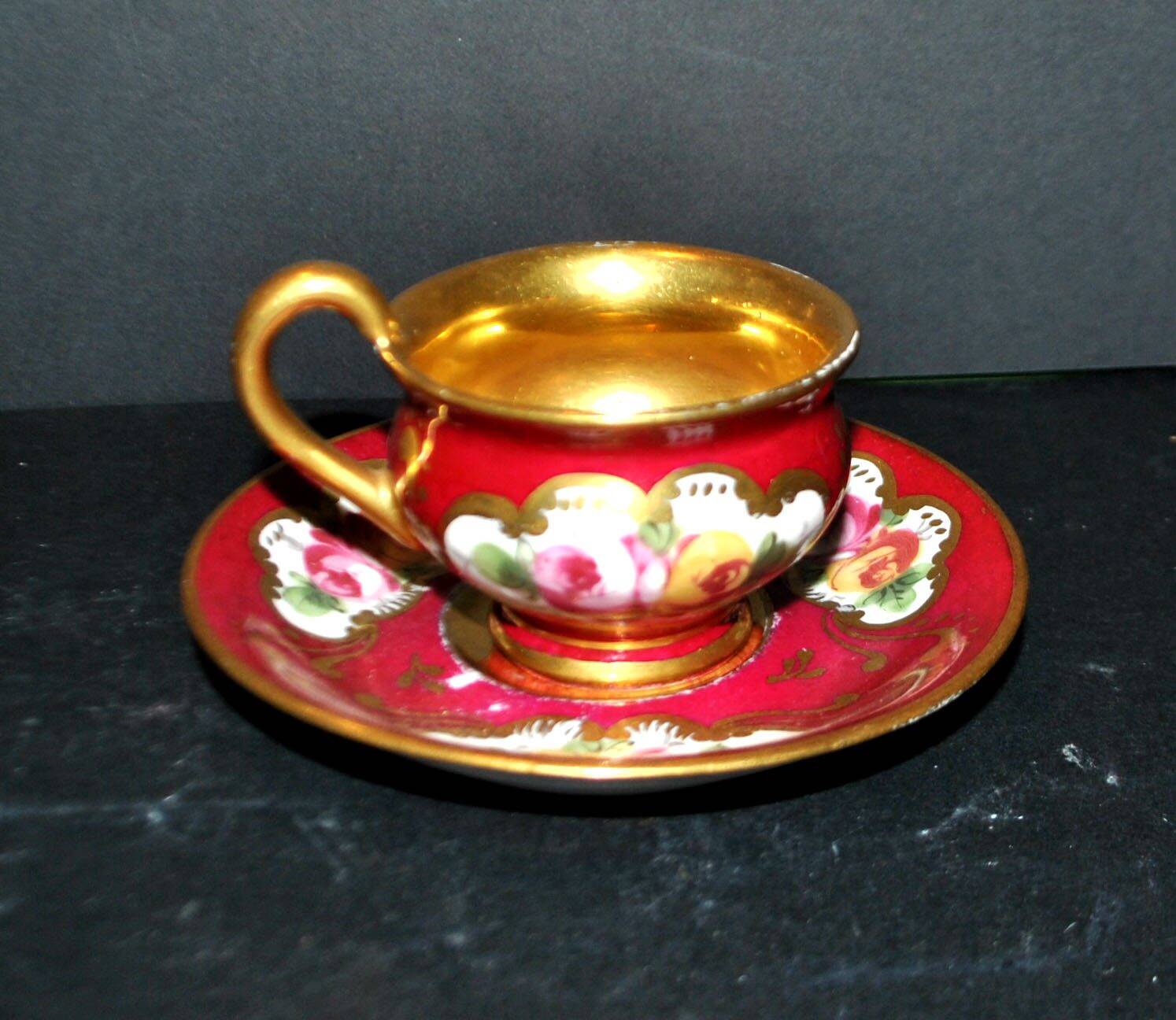 Limoges precious porcelain cup decorated in fuchsia pink and gold, signed MAB