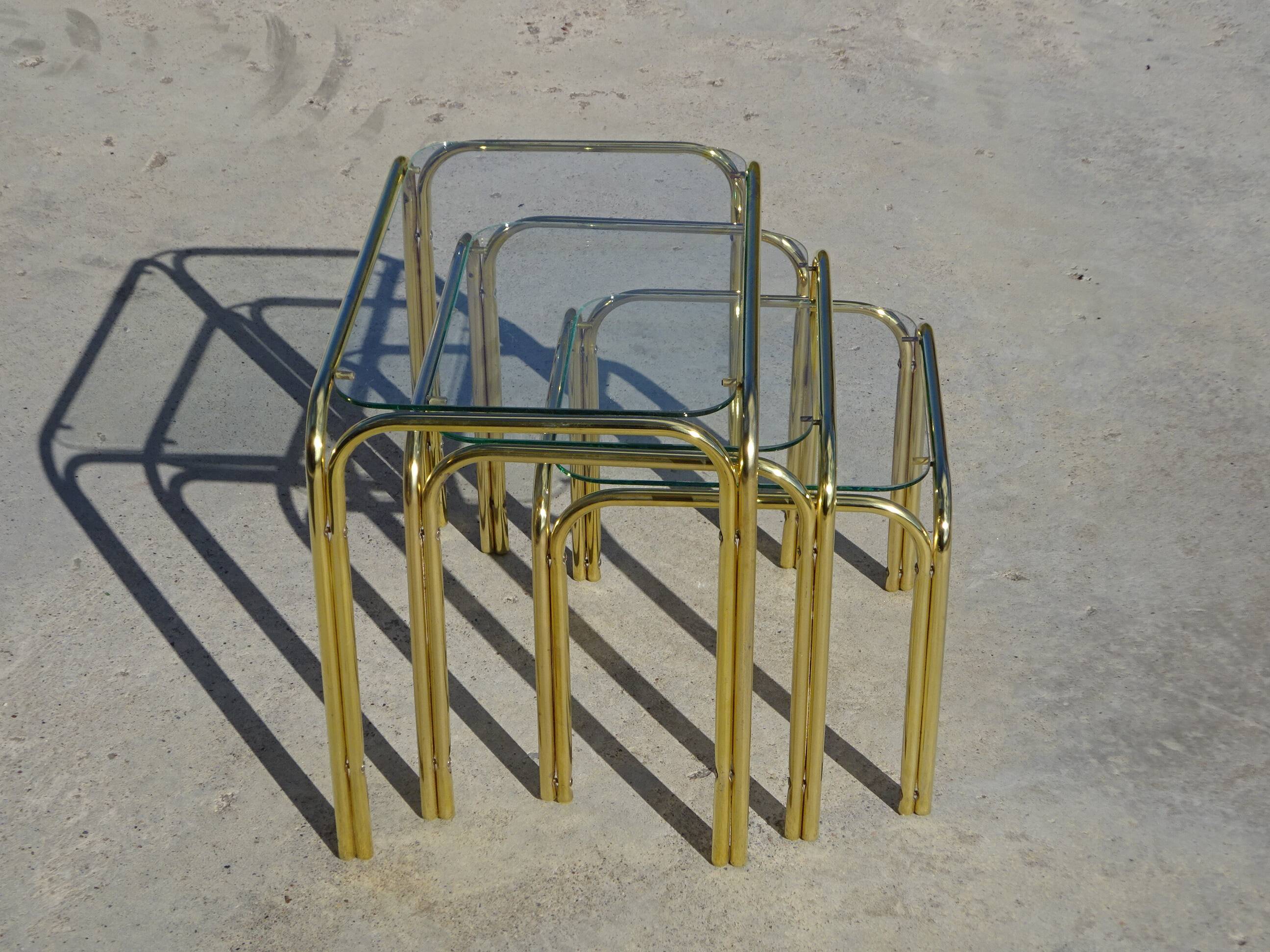 Nesting tables in gold-tone metal and glass