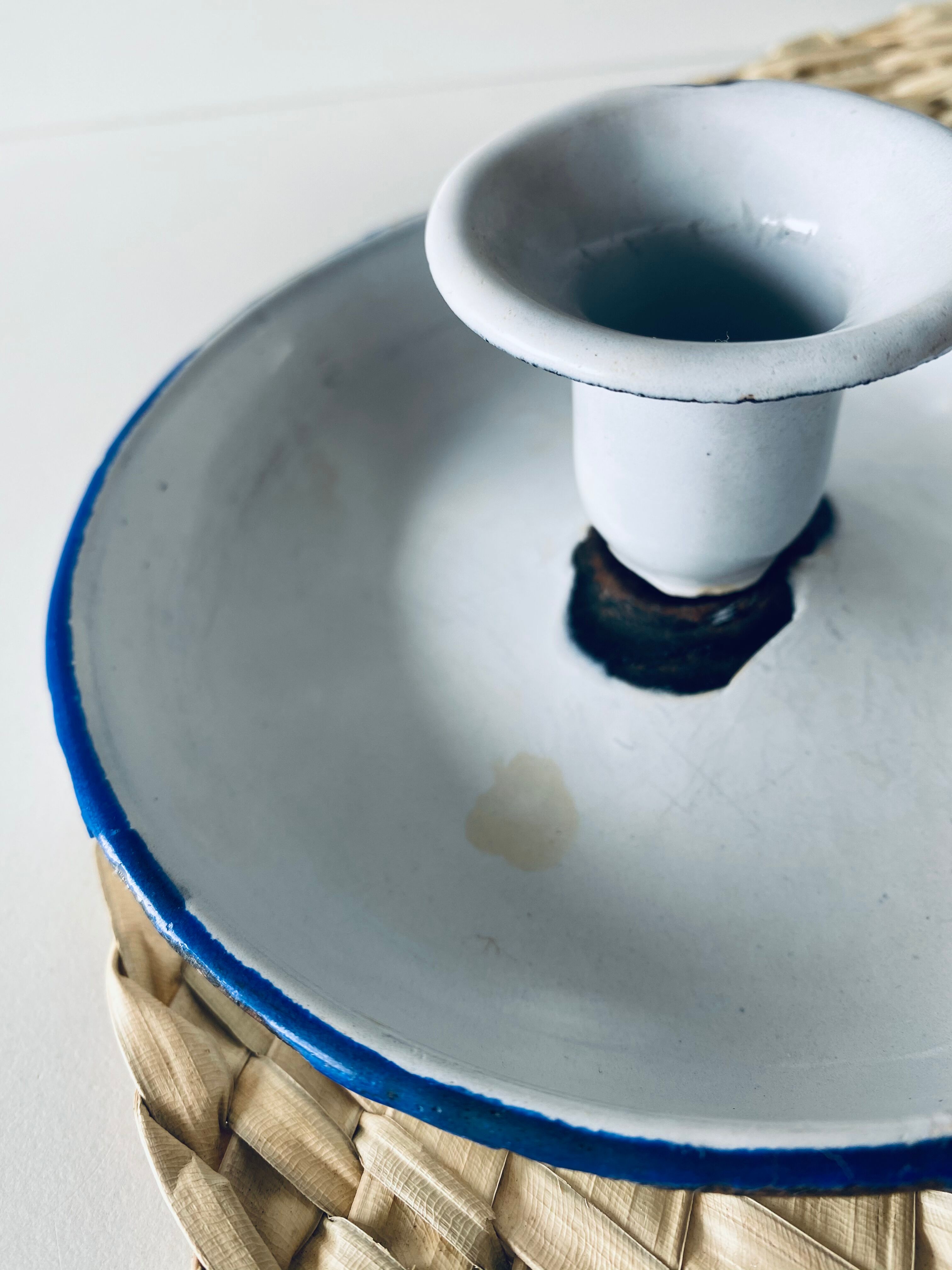 Old enamelled metal candlestick