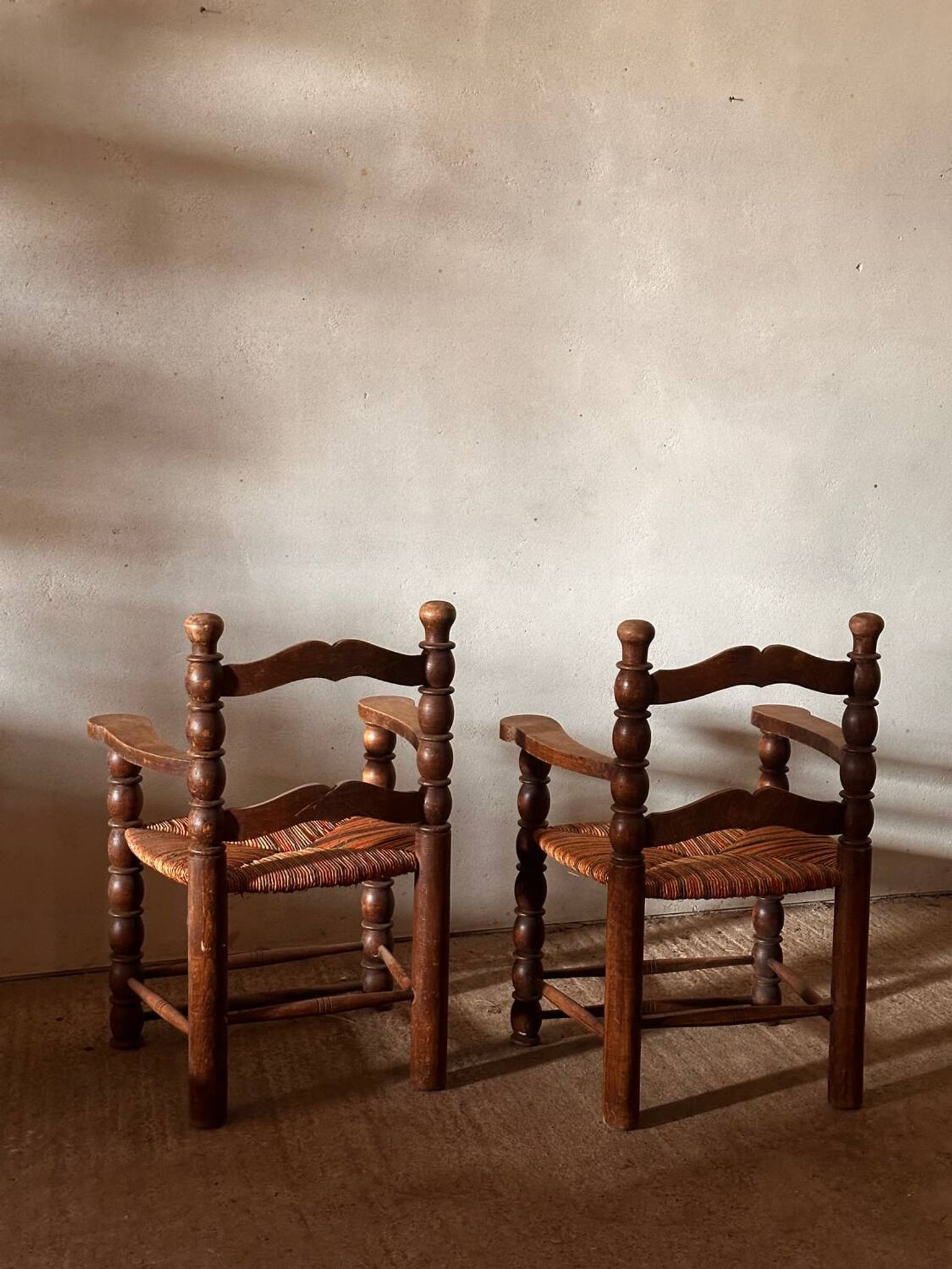Pair of French spindle chairs in the style of Charles Dudouyt.