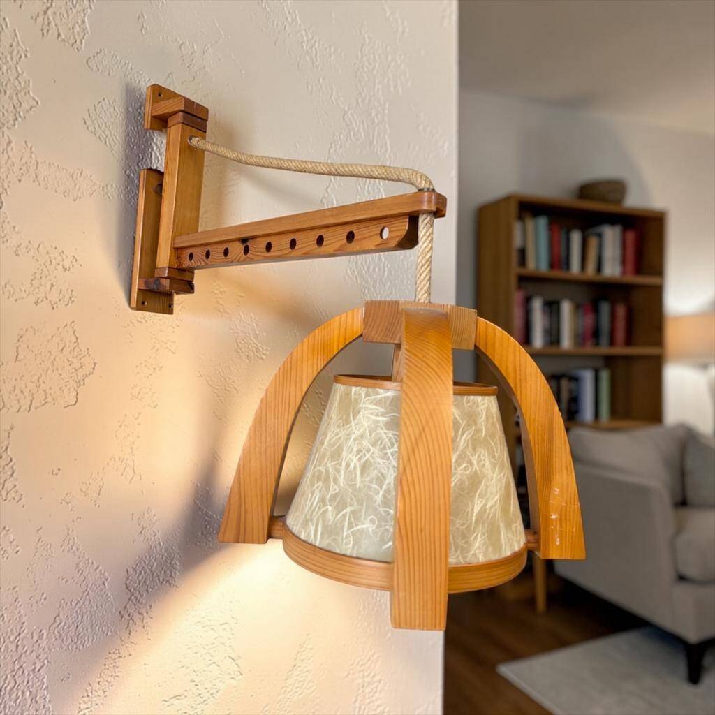 Vintage wooden wall lamp with rope detail.