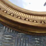 Antique oval mirror in gilded stucco with gold leaf, 19th century
