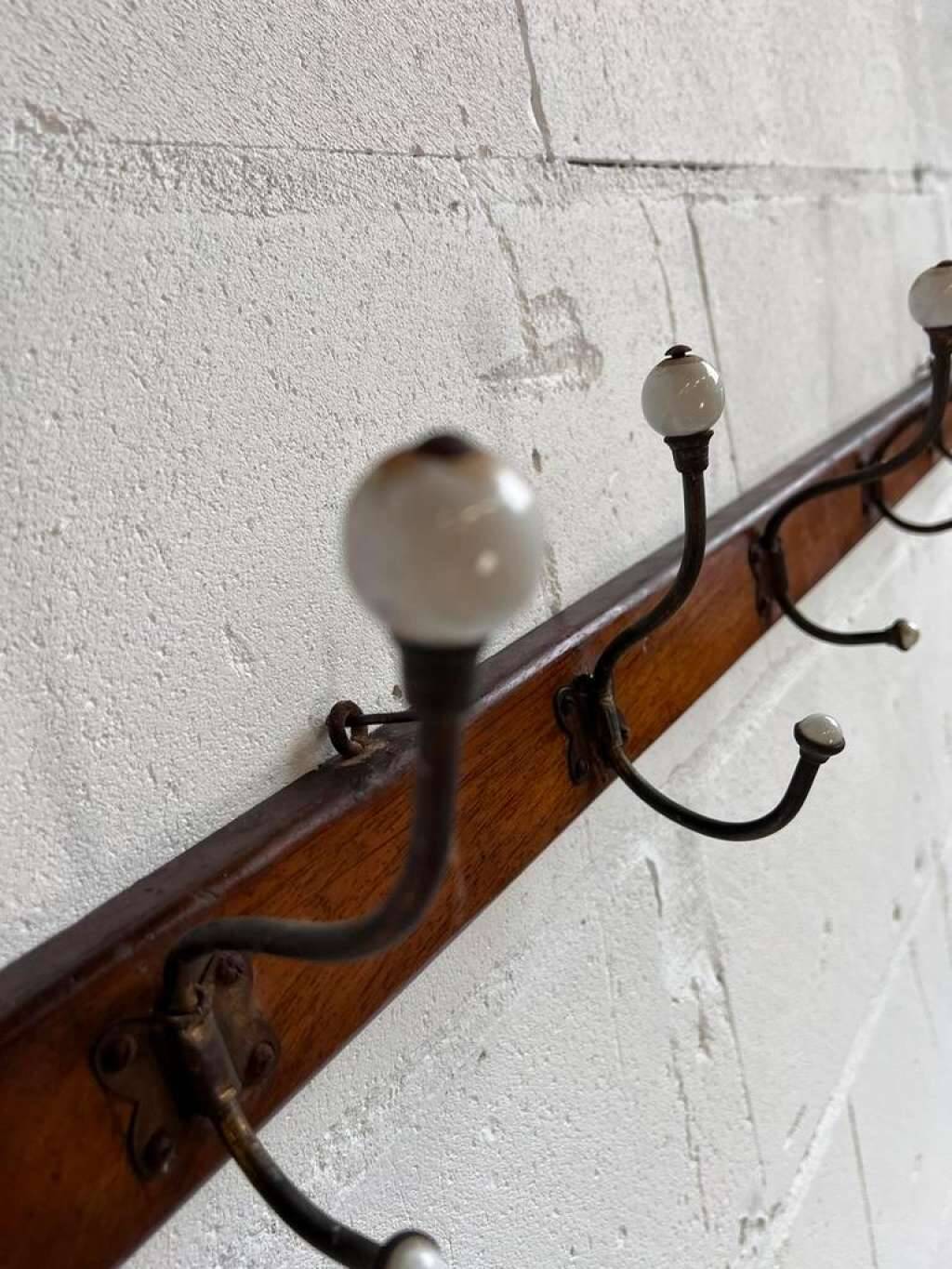 Vintage industrial wooden coat rack with porcelain hooks