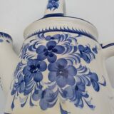 Earthenware watering can vase with floral decoration. St Clement.