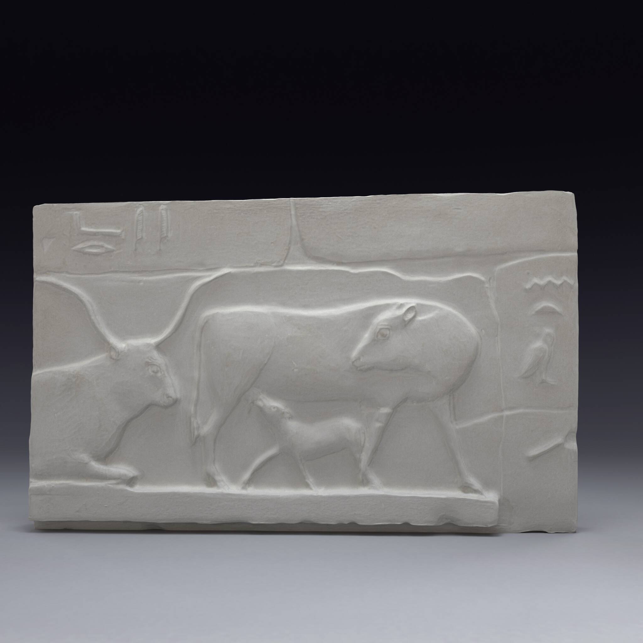 Plaster depicting two cows and a calf, based on an Egyptian fresco.