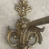 Adjustable wall light in brass and gold metal.