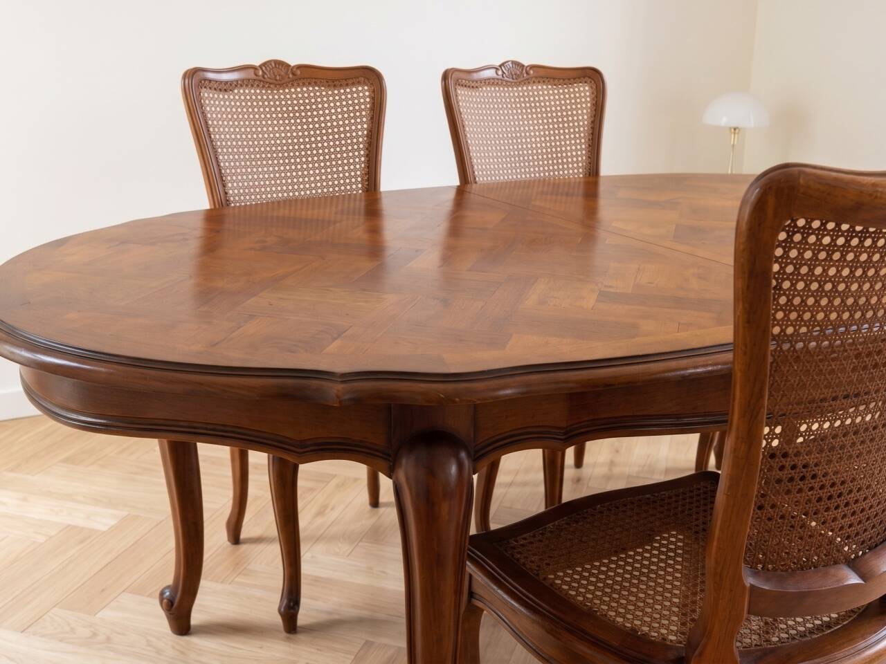 Oval dining table and 6 caned chairs in Louis XVI style made of wood.