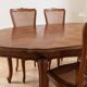 Oval dining table and 6 caned chairs in Louis XVI style made of wood.