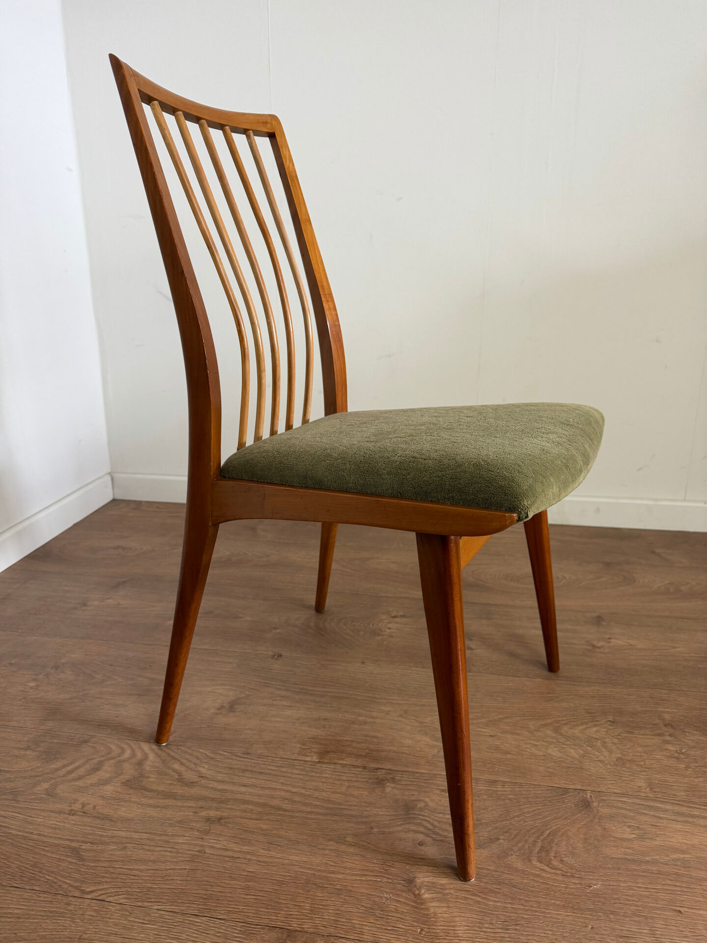 Scandinavian chairs with green velvet upholstery.
