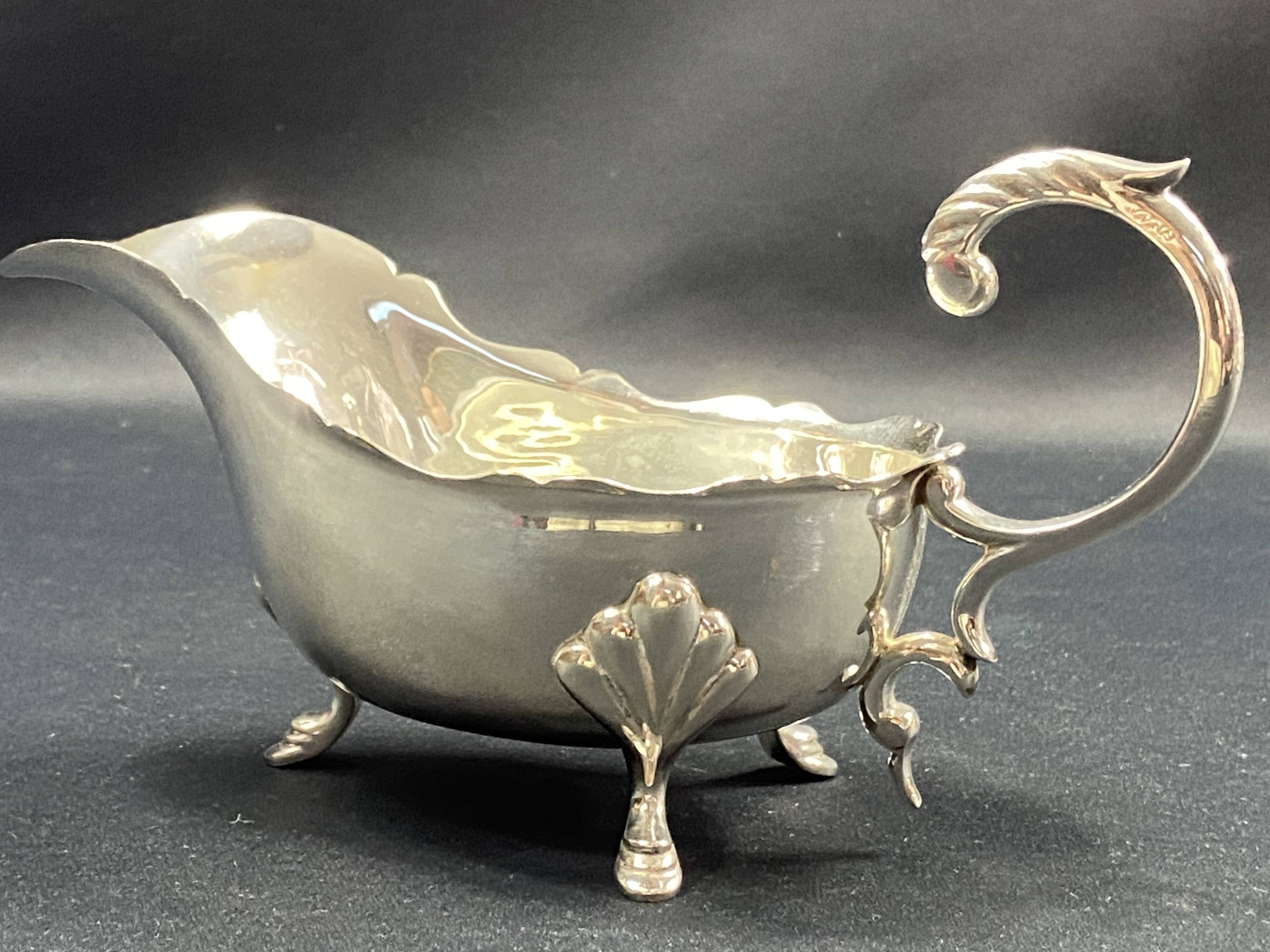English George III style silver plated tripod sauce boat