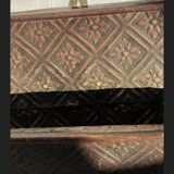 Hammered leather wall mail holder on wood.