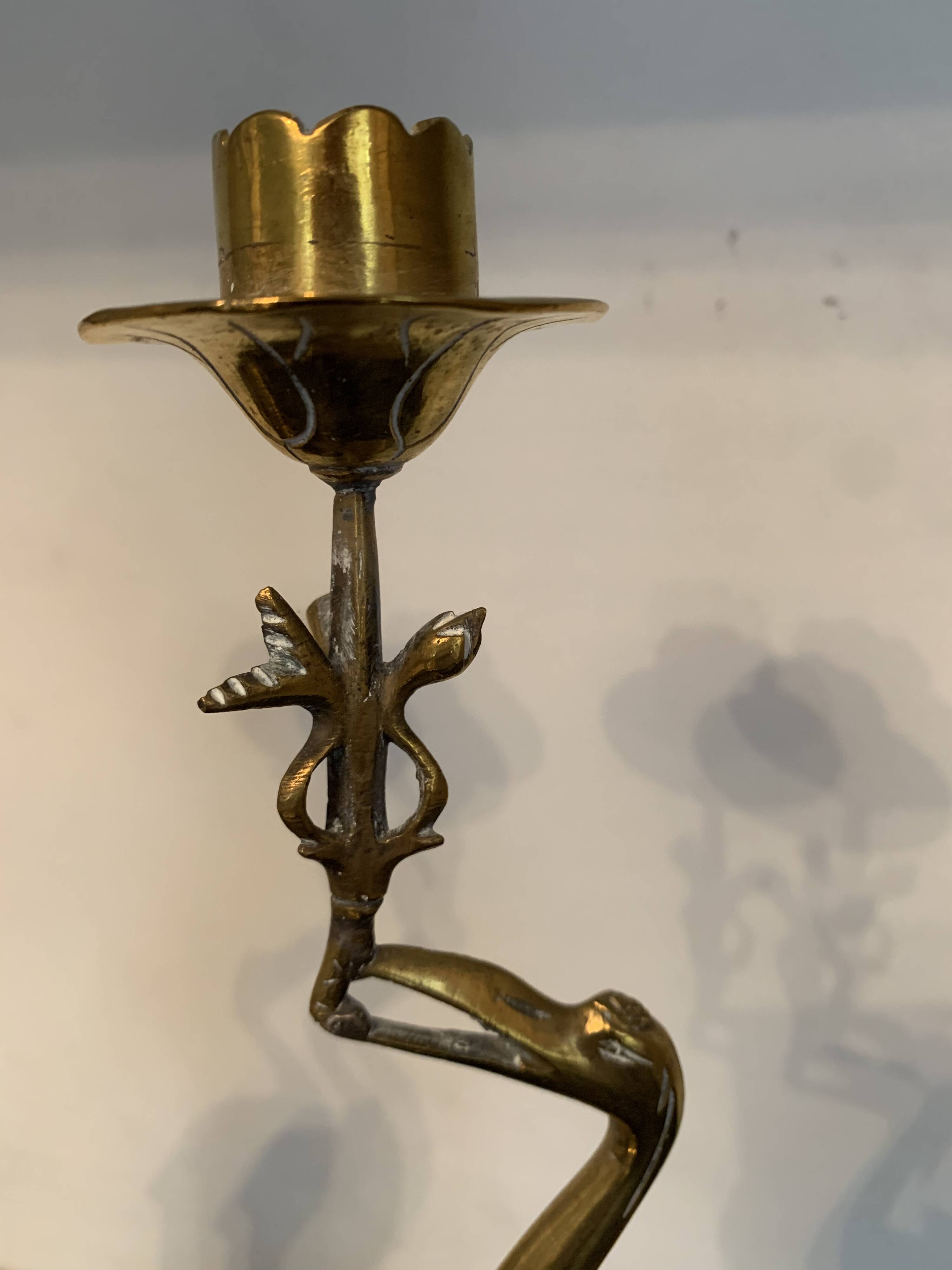 Pair of chiseled and gilded bronze candlesticks depicting perched waders