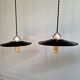 Three industrial suspensions in black enamelled sheet metal.