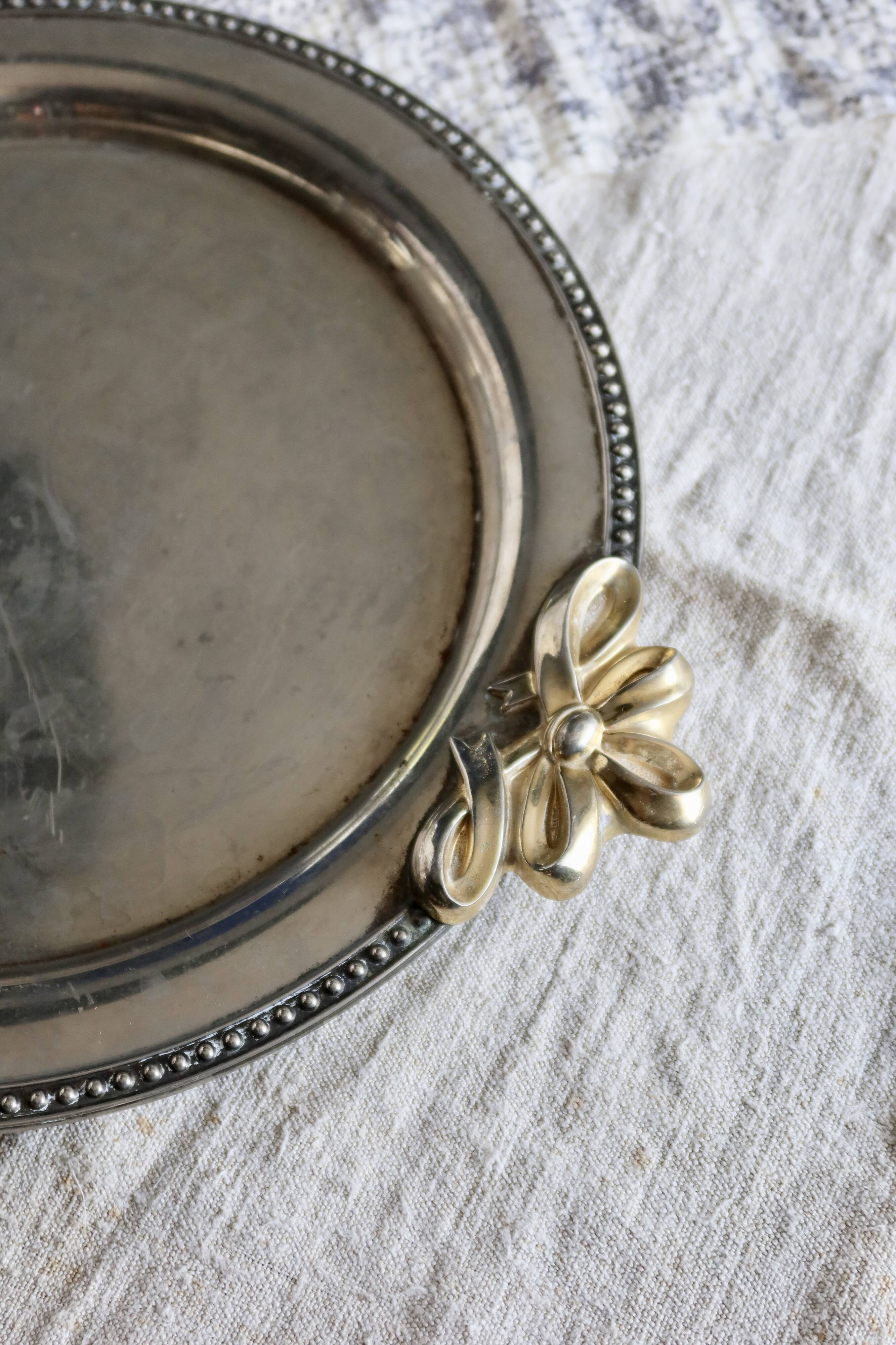 Vintage round silver metal serving tray with gold knot handles