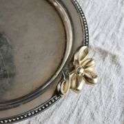Vintage round silver metal serving tray with gold knot handles
