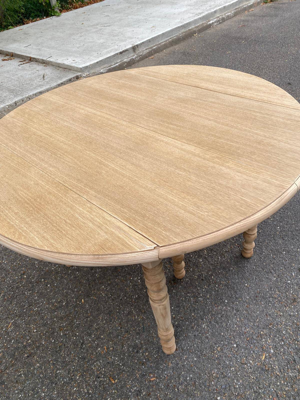 Round dining table with extendable leaves, Louis Philippe style, stripped in raw oak.