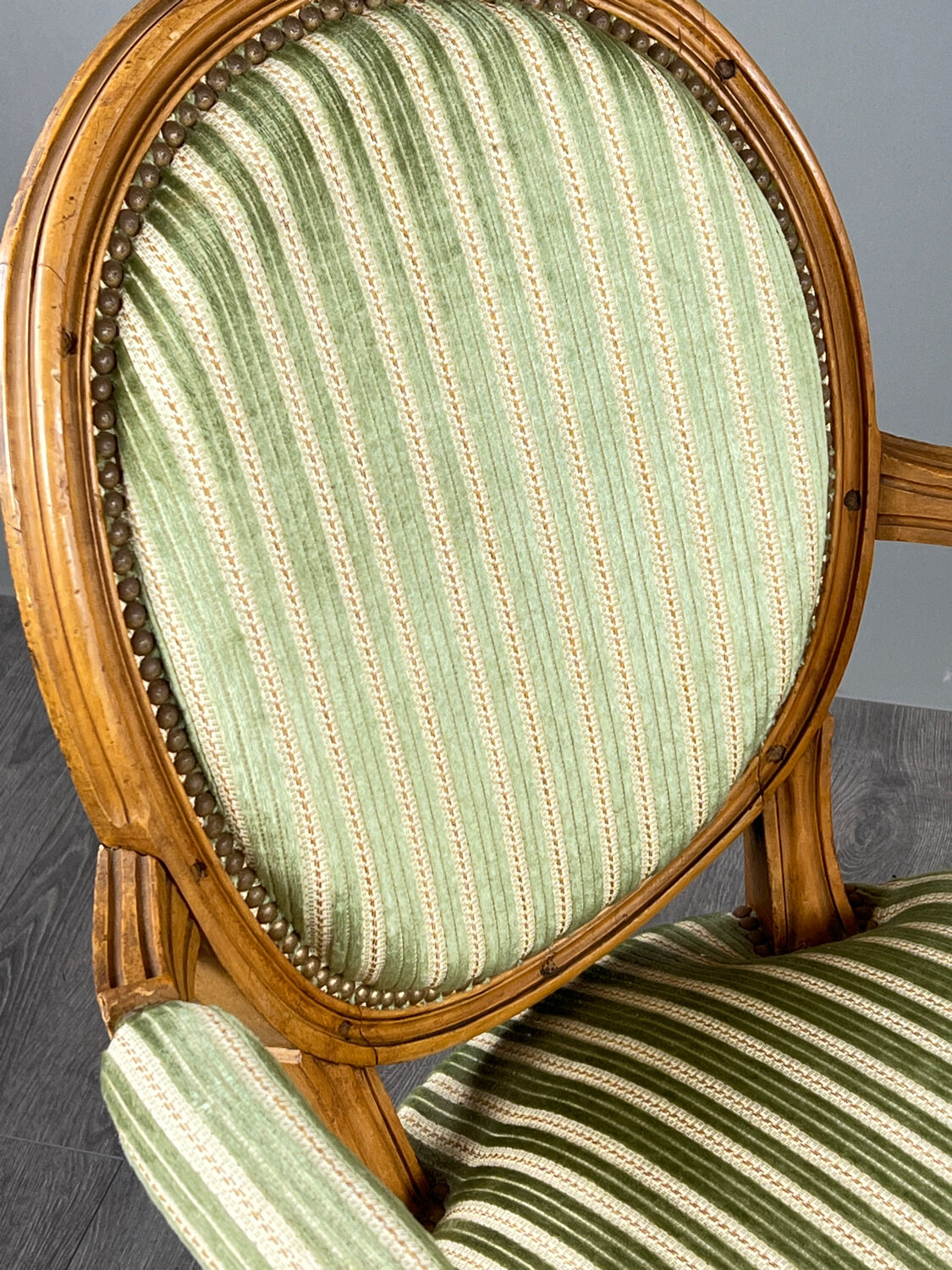 Pair of Louis XVI style armchairs in striped green fabric, 20th century.