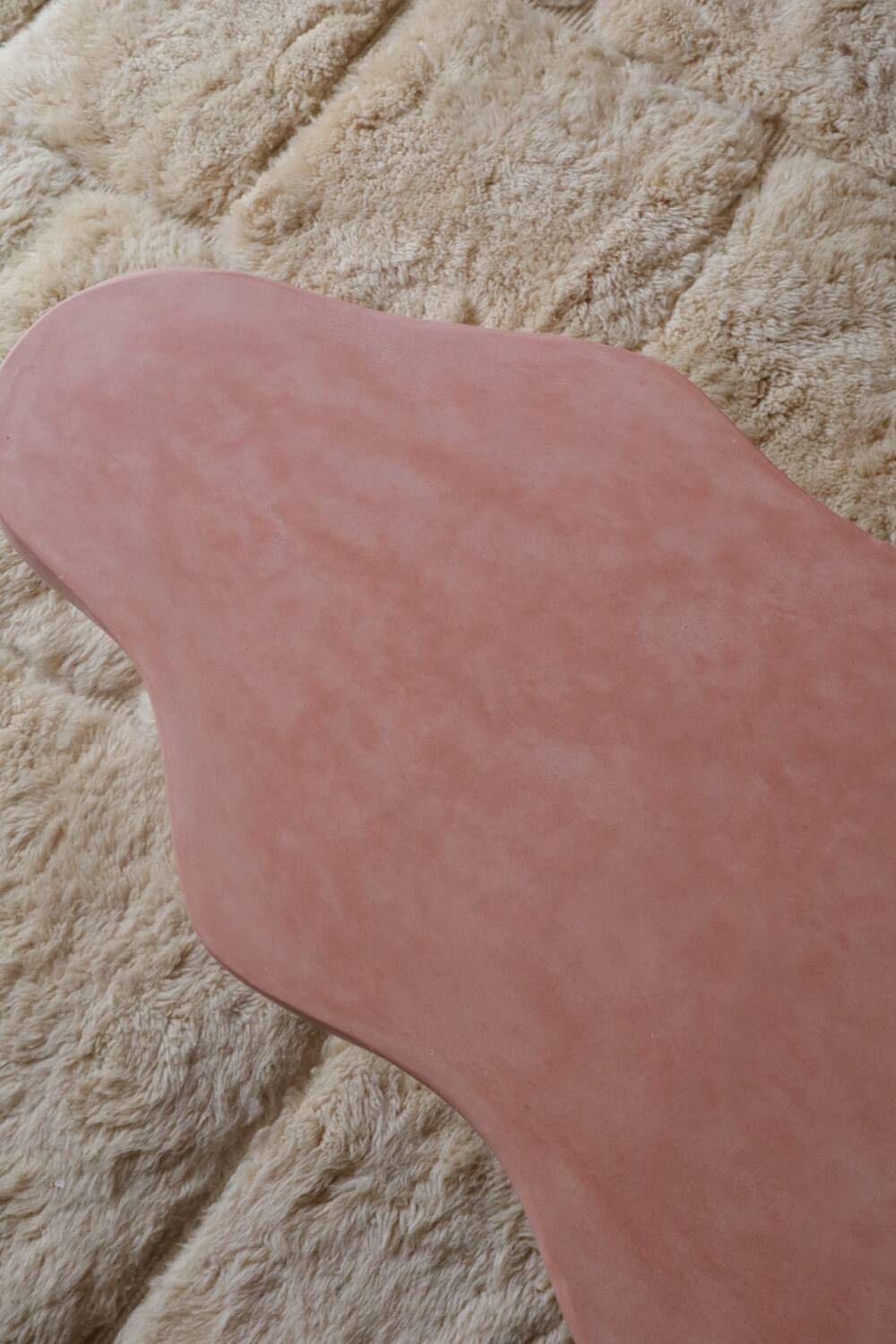 Organic shaped coffee table in pink teracotta tadelakt