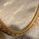 Golden oval mirror