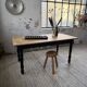 Oak farmhouse table with turned black legs.