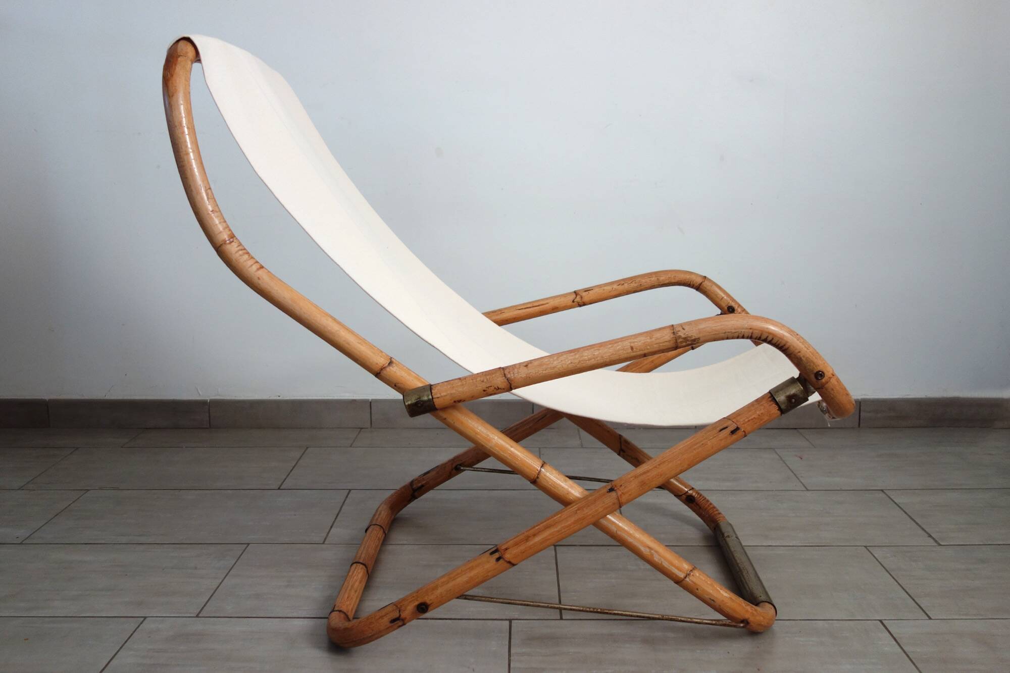 Pair of folding bamboo and brass deck chairs, Italy, 1960s.