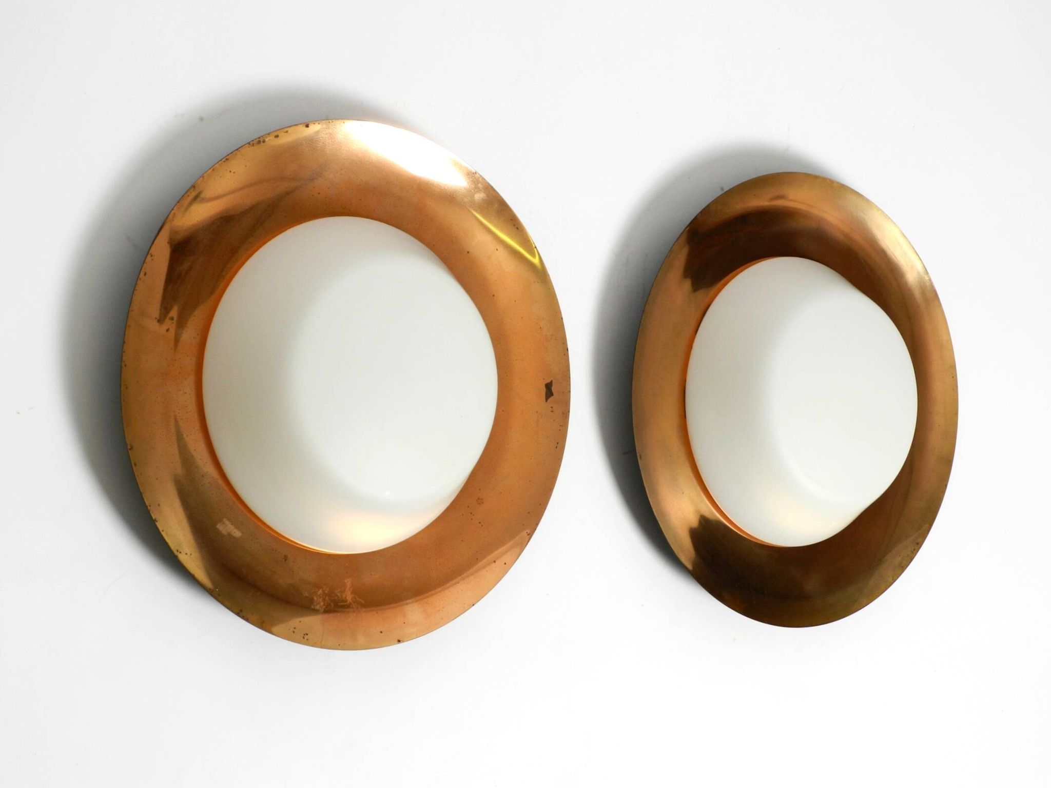 Pair of Mid Century wall or ceiling lamps made of glass with copper-plated
