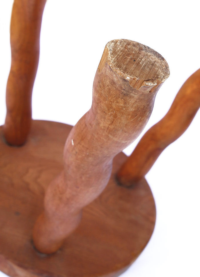 Tripod stool of folk art in light wood and wavy feet