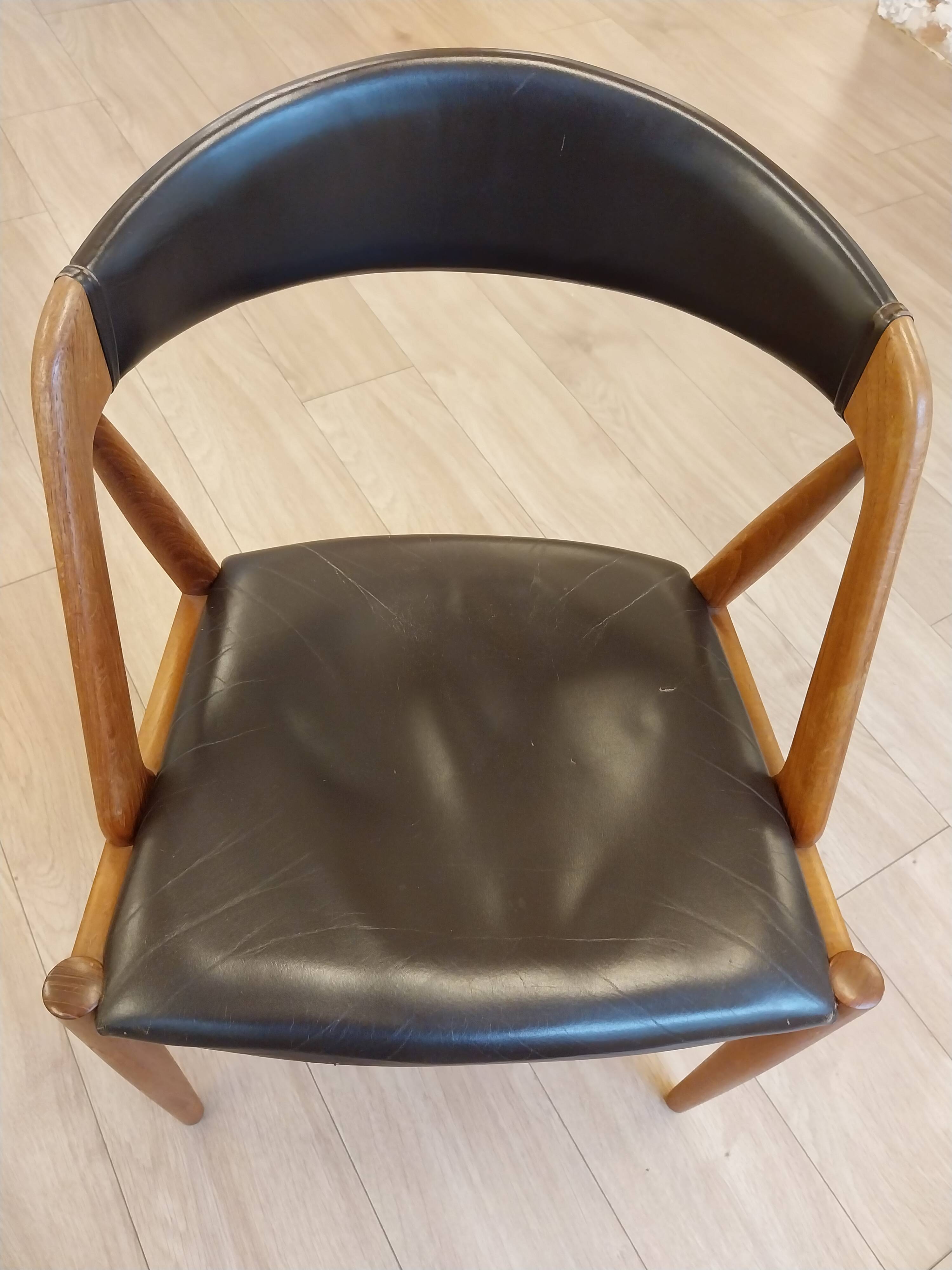 Set of 6 vintage Kai Kristiansen chairs in solid teak and black faux leather.