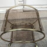 Service console with design / gilded metal wheels and smoked glass