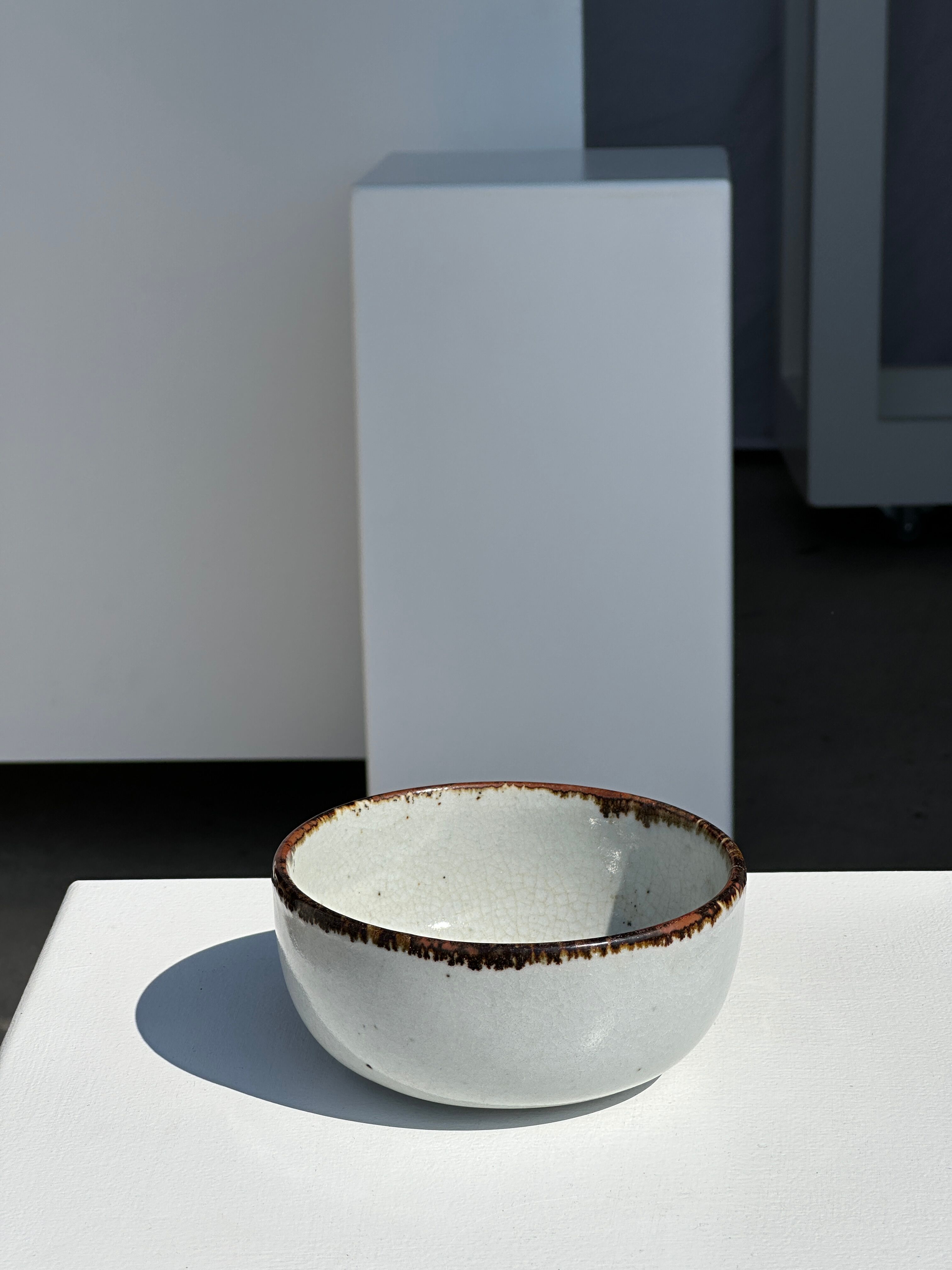 Small white glazed ceramic bowl black edges
