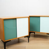 A pair of vintage mid-century bedside tables with glass sliding doors