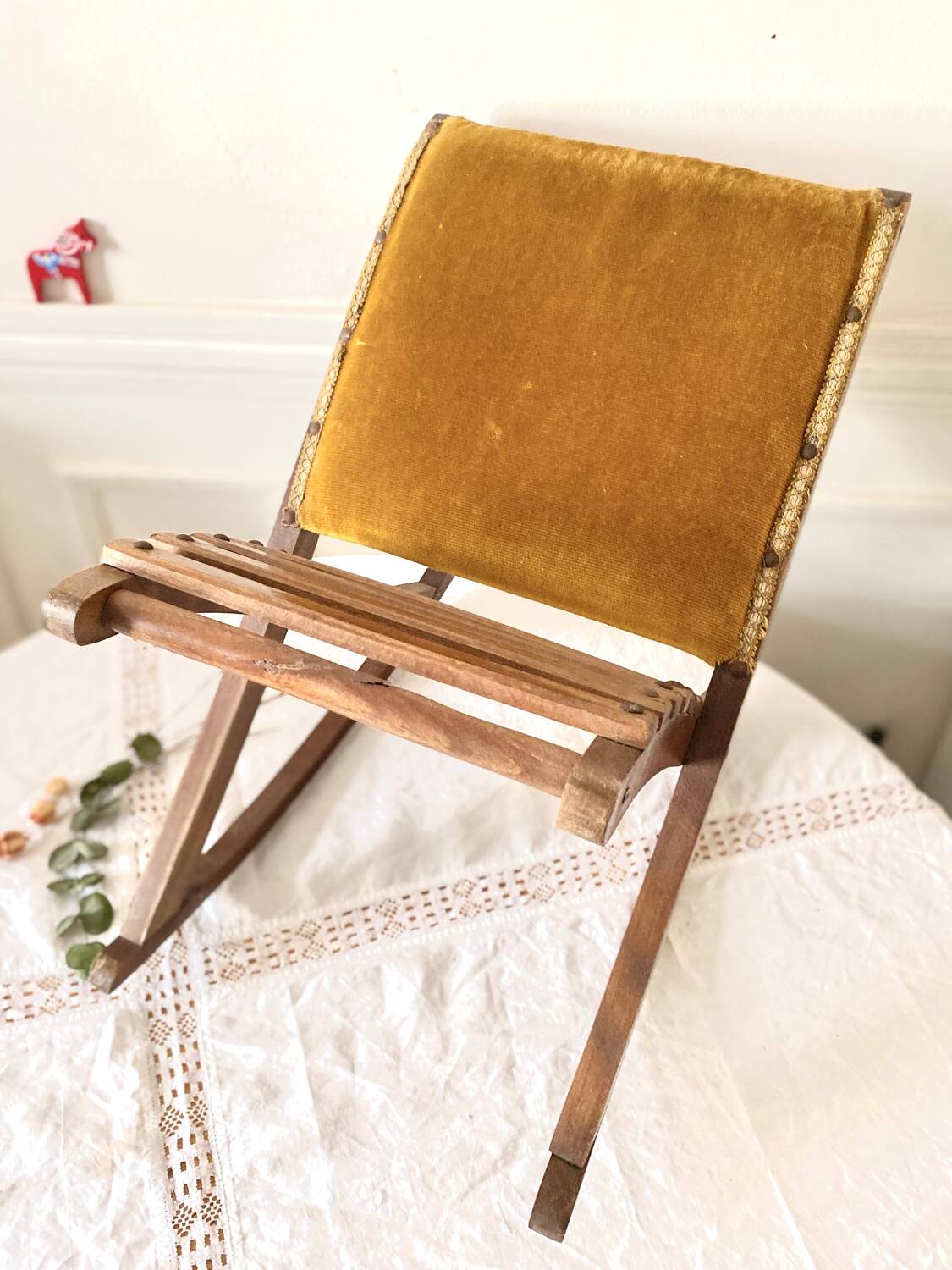 Old wooden rocking footrest with velvet fabric
