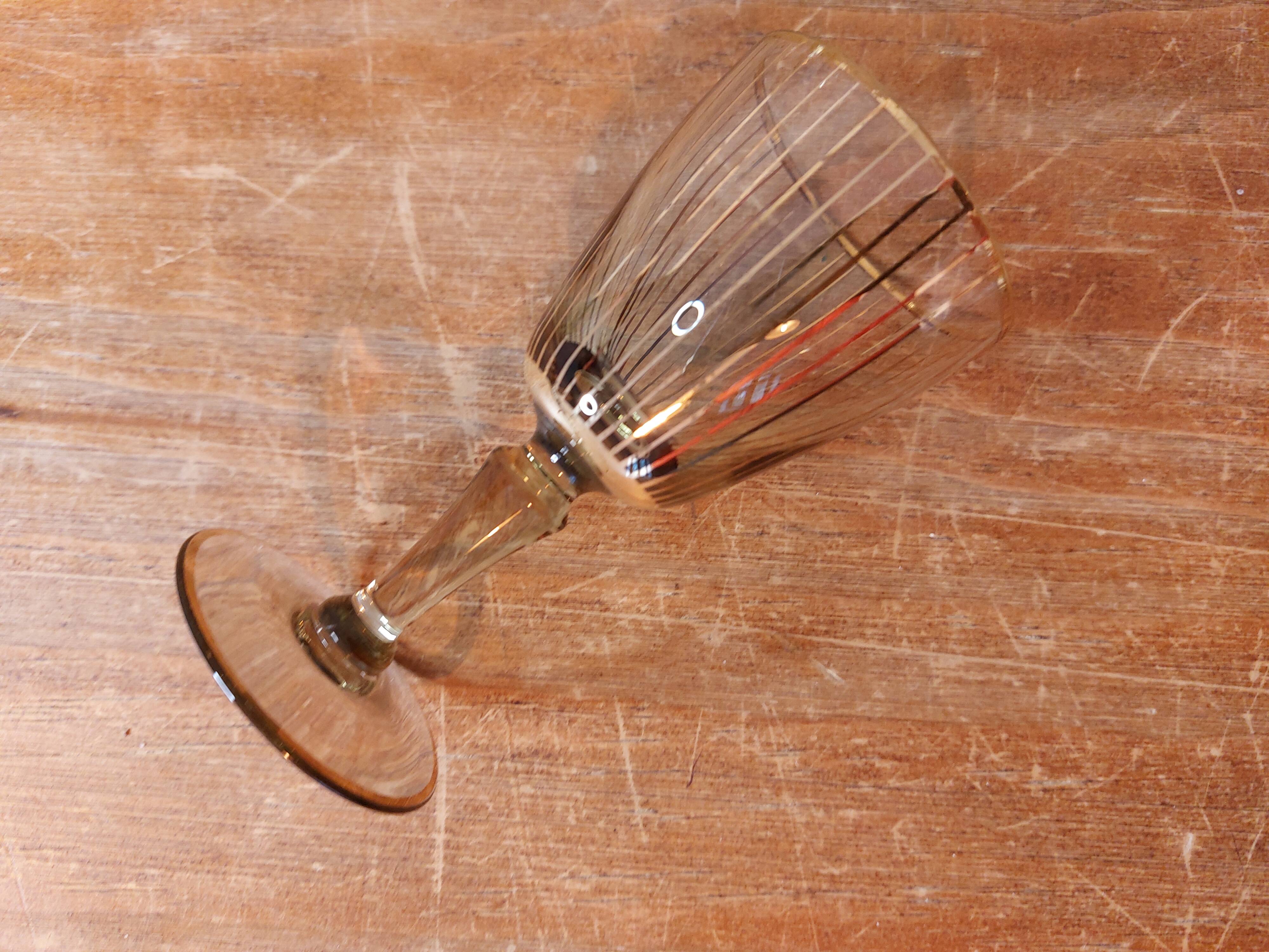 Vintage liqueur service, carafe and 7 amber brown glasses with gold edging