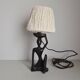 Ebony lamp with seated woman / 1930s