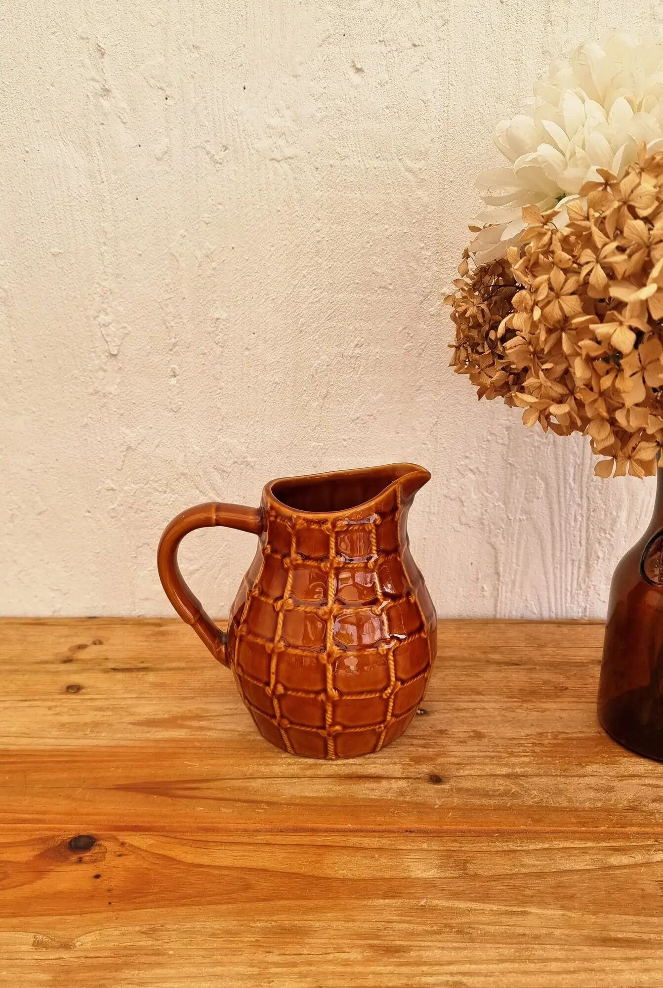 Vintage Saint Clément pitcher with a caramel checkered design.