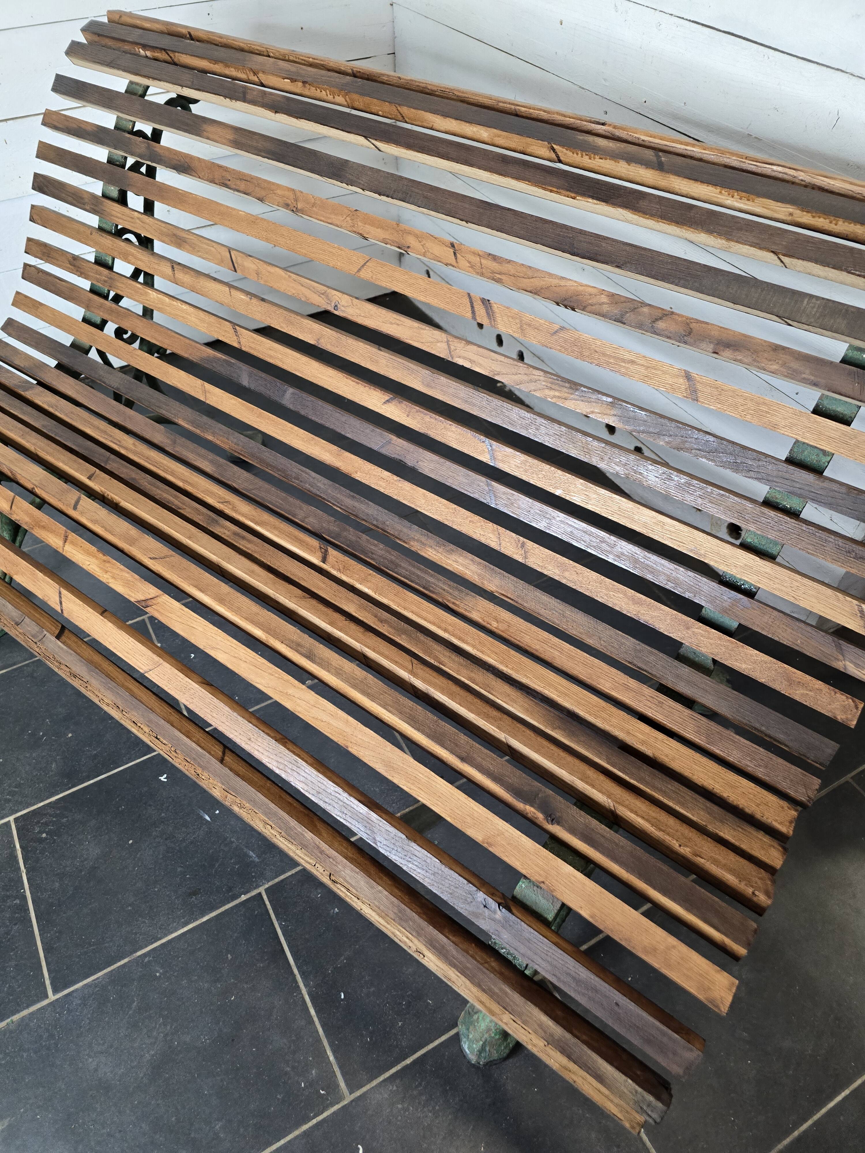 Old cast iron garden bench with oak slats