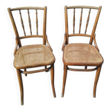 Set of 2 antique bistro chairs. Curved and turned wood.